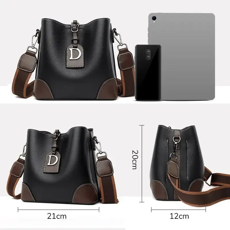Black handbag with brown accents and dimensions displayed on a white background