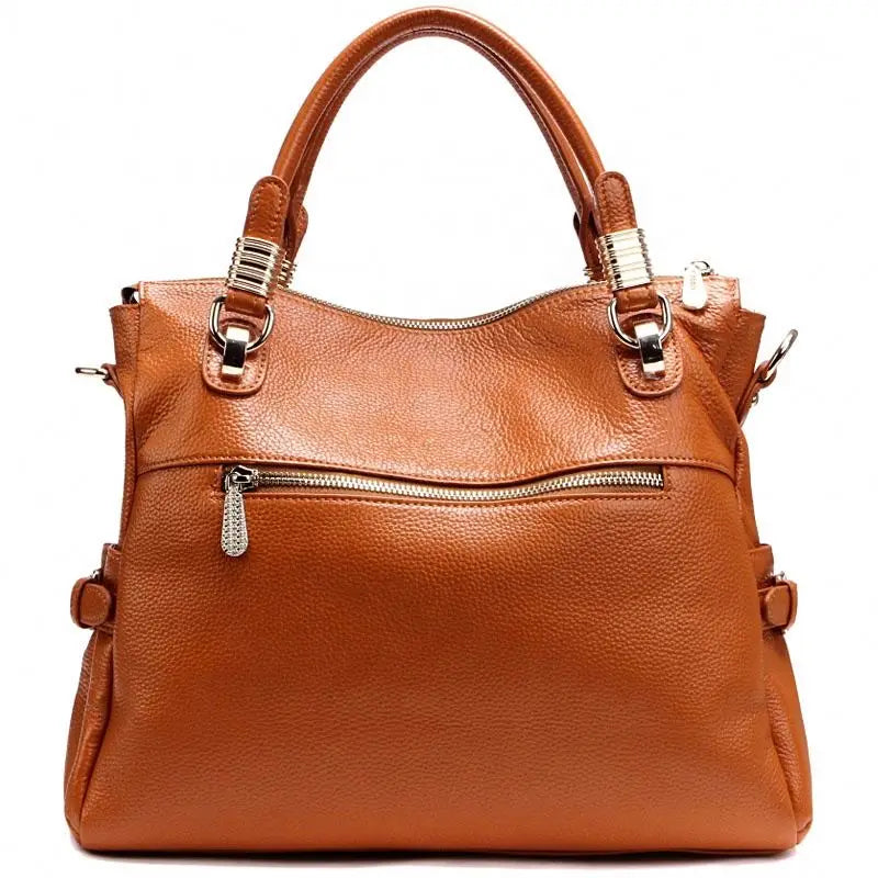 Brown leather handbag with gold accents on a white background