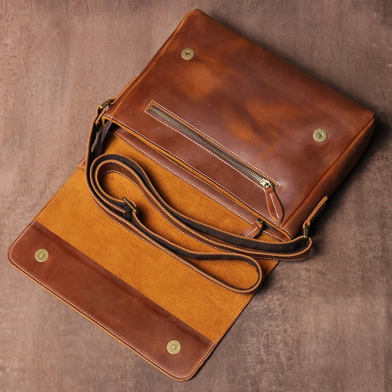 Brown leather crossbody bag on a beige background