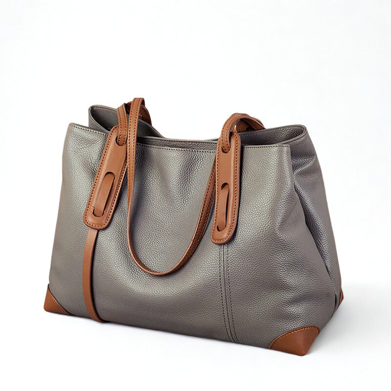 Gray handbag with brown handles and accents on a white background