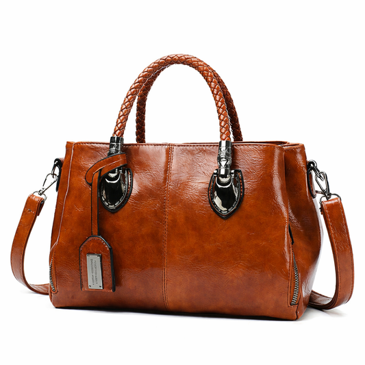 Brown leather handbag with braided handle on a white background
