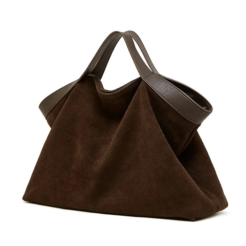 Brown handbag with leather handle on a white background